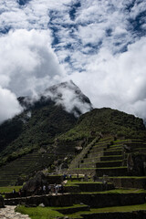 Fototapeta na wymiar Views of Macchu Pichu through the mist and the surrounding mountains, Peru