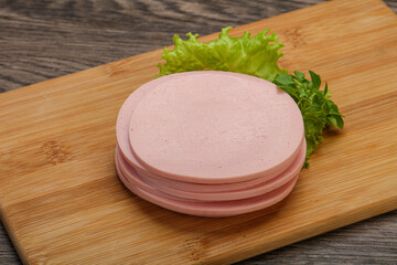 Sliced pork natural sausages over board