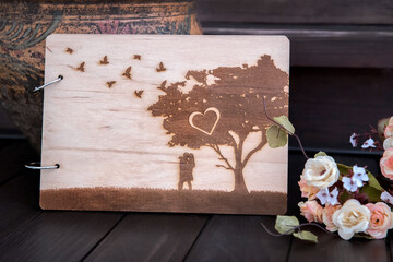 Blank wedding note paper with flowers on a dark wooden background