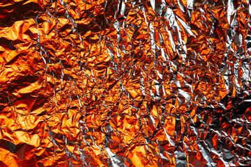 crumpled foil background illuminated with colored lights