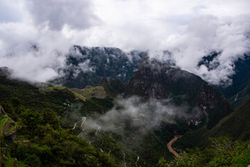 Fototapeta premium Views of Macchu PIcchu amidst the clouds in Peru