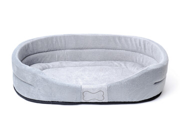 Empty pet bed on white with copy space