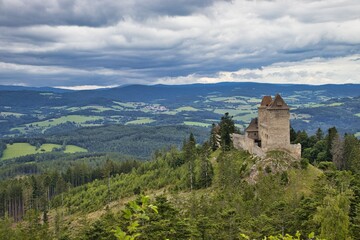 Fototapeta na wymiar The photo was taken in the middle of summer 2021. It shows views of the medieval castle Kašperk. This castle stands in the middle of the Sumava Mountains.