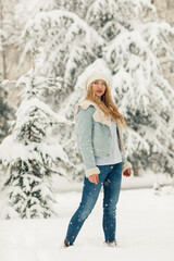 Young beautiful blonde woman in a snowy forest