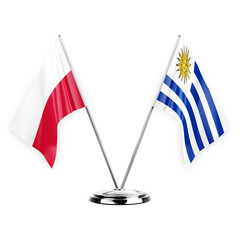 Two table flags isolated on white background 3d illustration, poland and uruguay