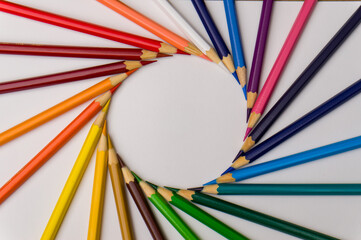 several colored pencils forming a circle