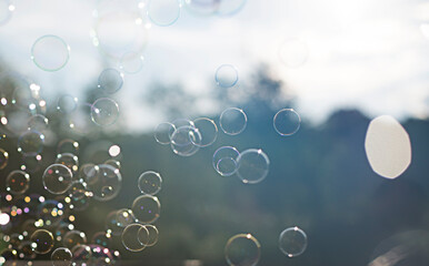 Background soap bubbles outdoor in the rays of the sun