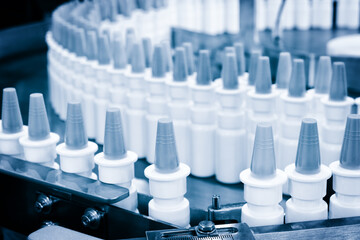 Close-up Many white plastic spray bottles for packaging liquid medicines or cosmetics in a row on a...