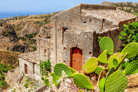 Small village of Pentedattilo, church and ruins of the abandoned village, Greek colony on Mount Calvario, whose form recalls the five fingers. Calabria, Italy