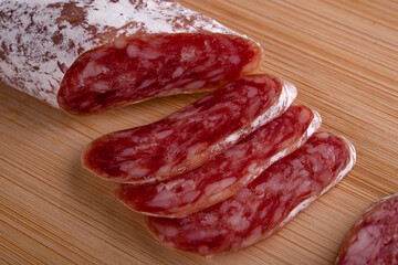 sliced smoked sausage on a wooden board