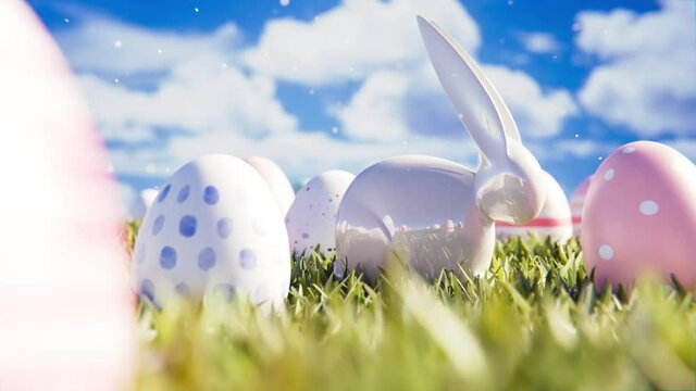 Ostern - Osterhase steht zwischen Ostereiern auf gr&uuml;ner Wiese vor blauem Hintergrund - Ostergr&uuml;&szlig;e