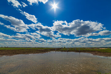 Clouds over flooded agricultural field