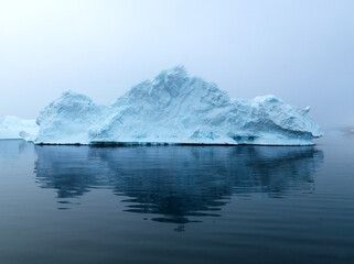 Naklejka na ściany i meble Icebergs on Arctic Ocean in Greenland. Climate Change on Pole region
