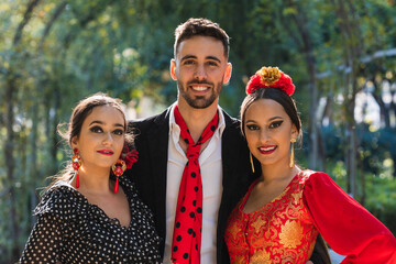 Portrait of flamenco dancers facing the camera while smiling outdoors