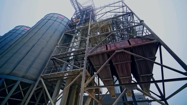 Large metal silo for storing grain. Modern industrial plant.