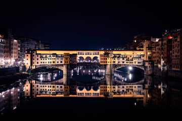 Fototapeta na wymiar Ponte Vecchio Florence at night, Firenze Italy, river Arno reflection