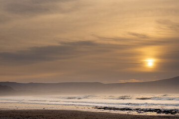 Naklejka na ściany i meble Strandhill beach at sunset. Sligo, Ireland. Big beach with stunning view and powerful ocean waves. Popular for surfing. Calm tranquil atmosphere.