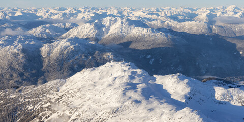 Aerial View from an Airplane of Whistler Mountain covered in fresh snow during winter season....