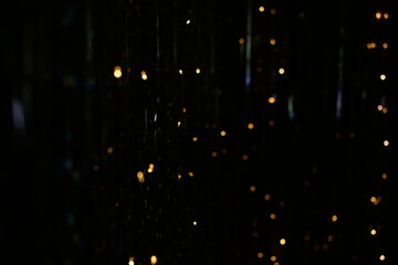 abstract texture, golden bokeh particles and highlights on dark background. 