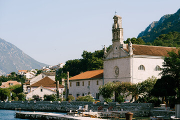 Facade of the Church of St. Nicholas with a bell tower in Prcanj on the shore of the Bay of Kotor