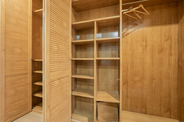 Wardrobe closet interior with shelves and rod for hanging coats and shirts