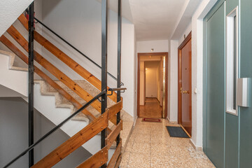 Stairs of residential apartment building with elevator and stone tile flooring