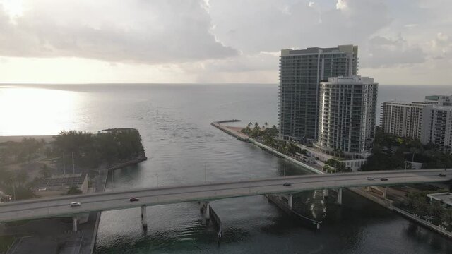 Sunrise aerial: Haulover Inlet channel and Collins Ave Bridge, Miami