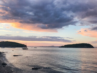 Sailboats in Frenchman's Bay in Bar Harbor, Maine at sunset with a storm rolling in