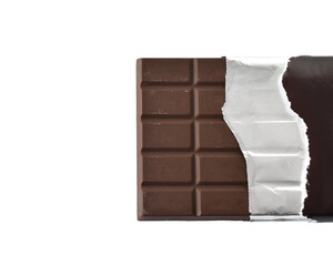 Chocolate bar wrapped in paper and foil on a white background