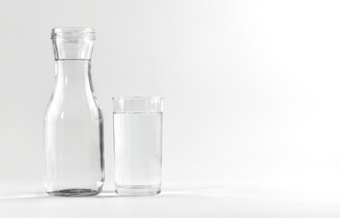 Water glass and bottle on a white background