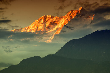 Beautiful last light from sunset on Mount Kanchenjugha, Himalayan mountain range, Sikkim, India. color tint on the mountains at dusk