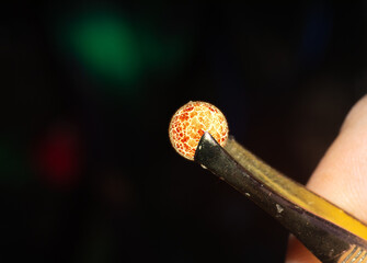 macro shot of tweezers holding a very small star