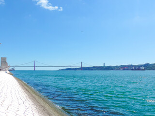 Obraz premium View of the 25th April Bridge and the Tejo River - Lisbon, Portugal