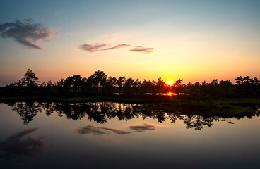 Fototapeta na wymiar gorgeous sunset on a bog lake in estonia