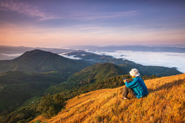 Fototapeta na wymiar The man hiking on high mountains and sea of mist . Doi Mon Chong, Chiangmai, Thailand.