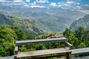 Fototapeta na wymiar Bench and View of Mountains from Ban Jabo Village in Northern Thailand