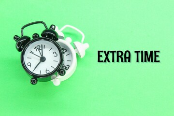 black and white alarm clock with the word extra time