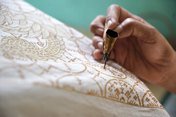 The process of making batik. batik is a handmade traditional art fashion from indonesia.