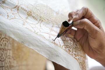 The process of making batik. batik is a handmade traditional art fashion from indonesia.