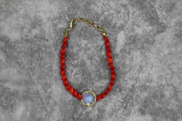 Fototapeta na wymiar Bracelet made of natural stones on a dark background. Top view