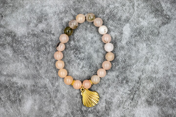 Bracelet made of natural stones on a dark background. Top view