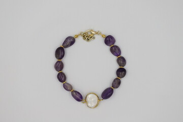 Bracelet made of natural stones on a white background. Top view