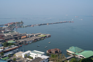Aerial view of Sriracha waterfront and pier showing floating buildings and small boats on a bright day