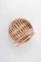 A bamboo steamer on a plain white background