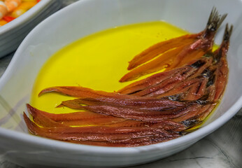 Naklejka premium Spanish pintxos of anchovies in vinegar in a Basque bar in San Sebastian, Spain