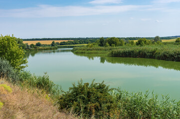 Fototapeta na wymiar Ukrainian rural landscape with small river Sura at late summer season