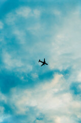 Fototapeta na wymiar silhouette of an airplane high in the sky