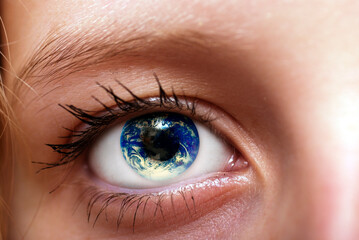 woman eye with planet Earth inside the iris