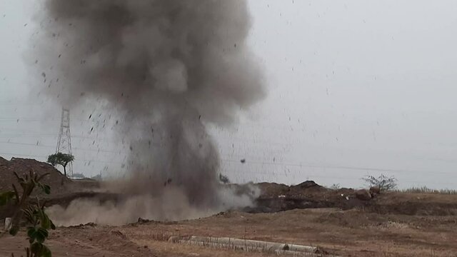 Blasting of rocks in a quarry. Crushing boulders using explosive technologies. The archive contains three versions of the explosion filmed from one point at different times of the day.