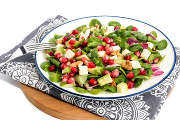Vegetable vitamin salad with fresh young spinach leaves, mozzarella cheese, pomegranate seeds, avocado, walnuts and lemon juice. 